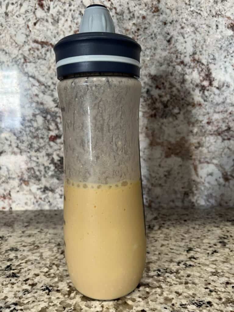 FBB_Beverage_Faux Mango Lassi Shaken v2_1200x1600. A Mango Lassi (Will's Version) in a shaker bottle.