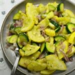 FBB_Side.Zucchini.Squash.Hero_.1200x1322.jpg. This is a photo of the seasoned zucchini and yellow squash on a plate with a fork, ready to enjoy.