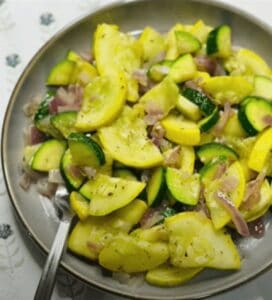 FBB_Side.Zucchini.Squash.Hero_.1200x1322.jpg. This is a photo of the seasoned zucchini and yellow squash on a plate with a fork, ready to enjoy.