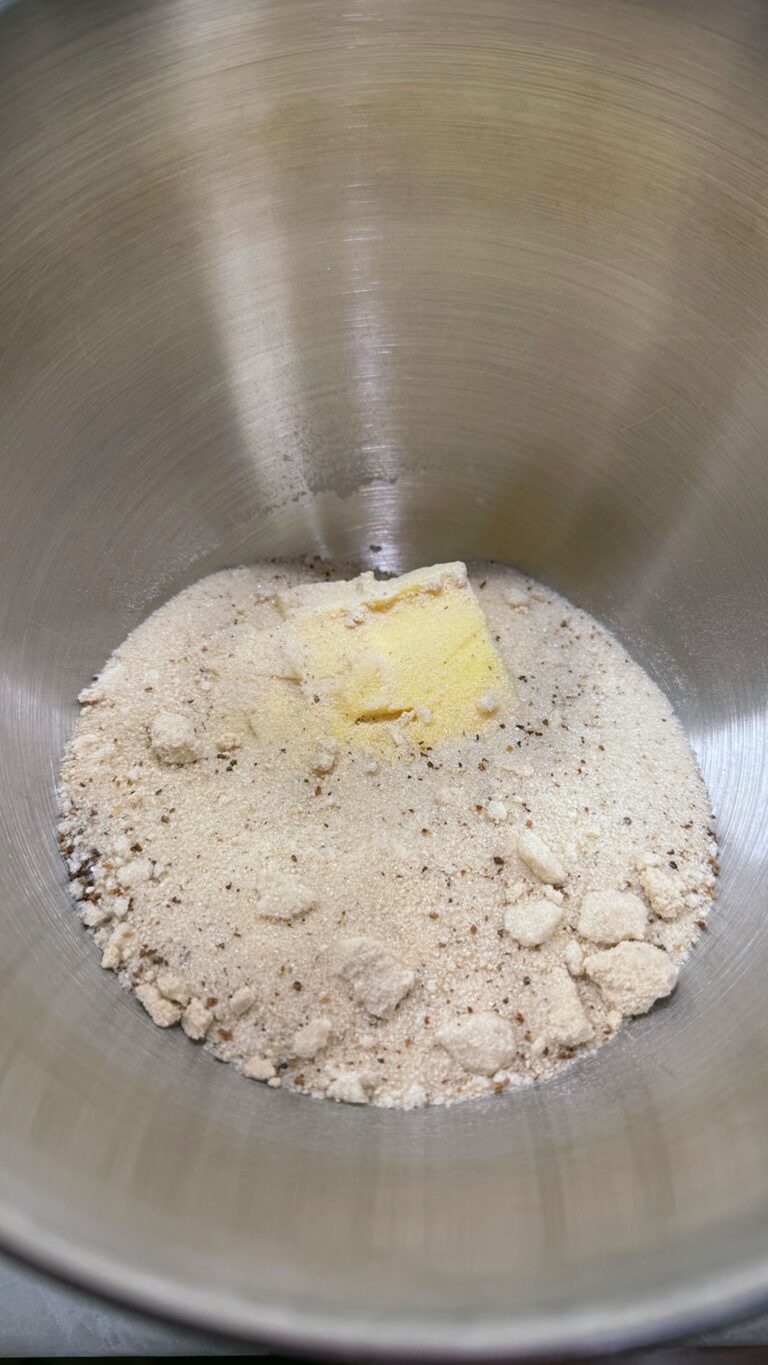 Butter nestled in a mixing bowl with flour, brown sugar, cardamom, and salt for the crumb topping.