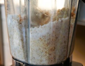 Pulsing walnuts and sugar together in a blender to make baklava filling.