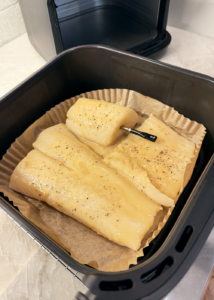 Black cod in air fryer basket with smart thermometer