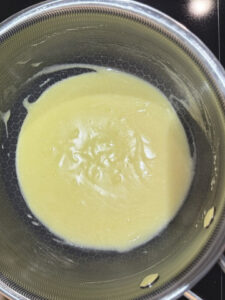 Finished hollandaise sauce in a small saucepan for Step 3