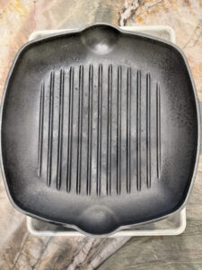 Cast-iron grill pan used as a weight to press tofu and remove excess moisture
