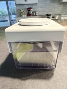 Pressing a block of tofu in a Tofubud press to remove excess moisture